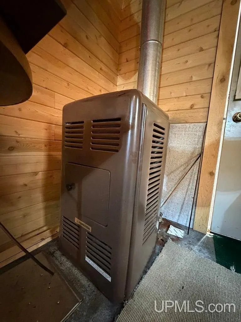 A propane space heater mounted on the cabin wall