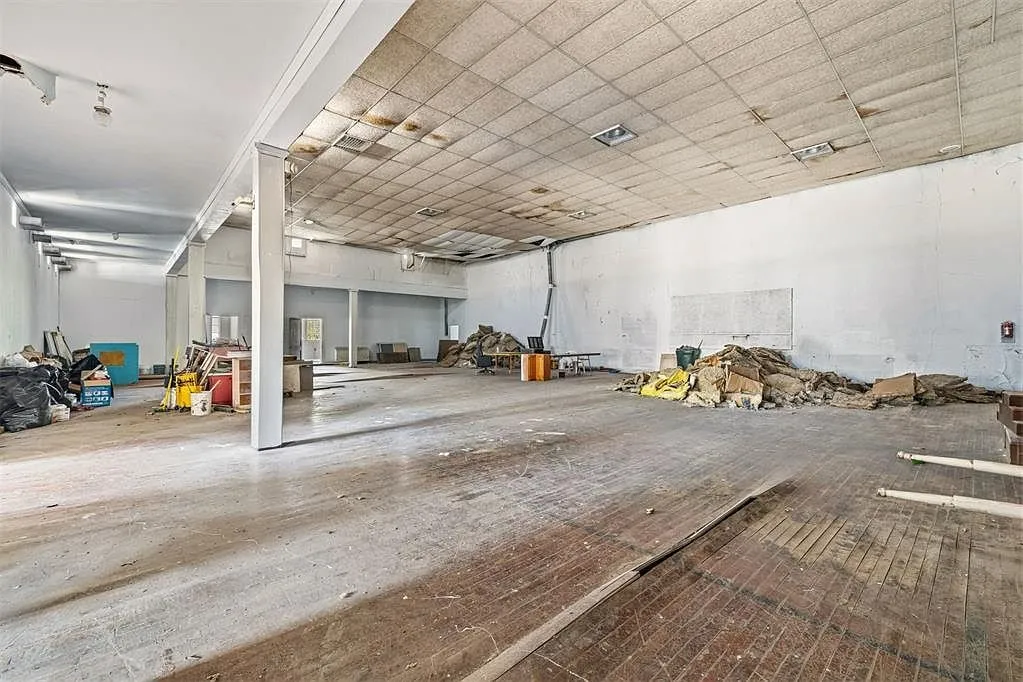 The auditorium with the columns, the tiled ceiling and the debris on the floor