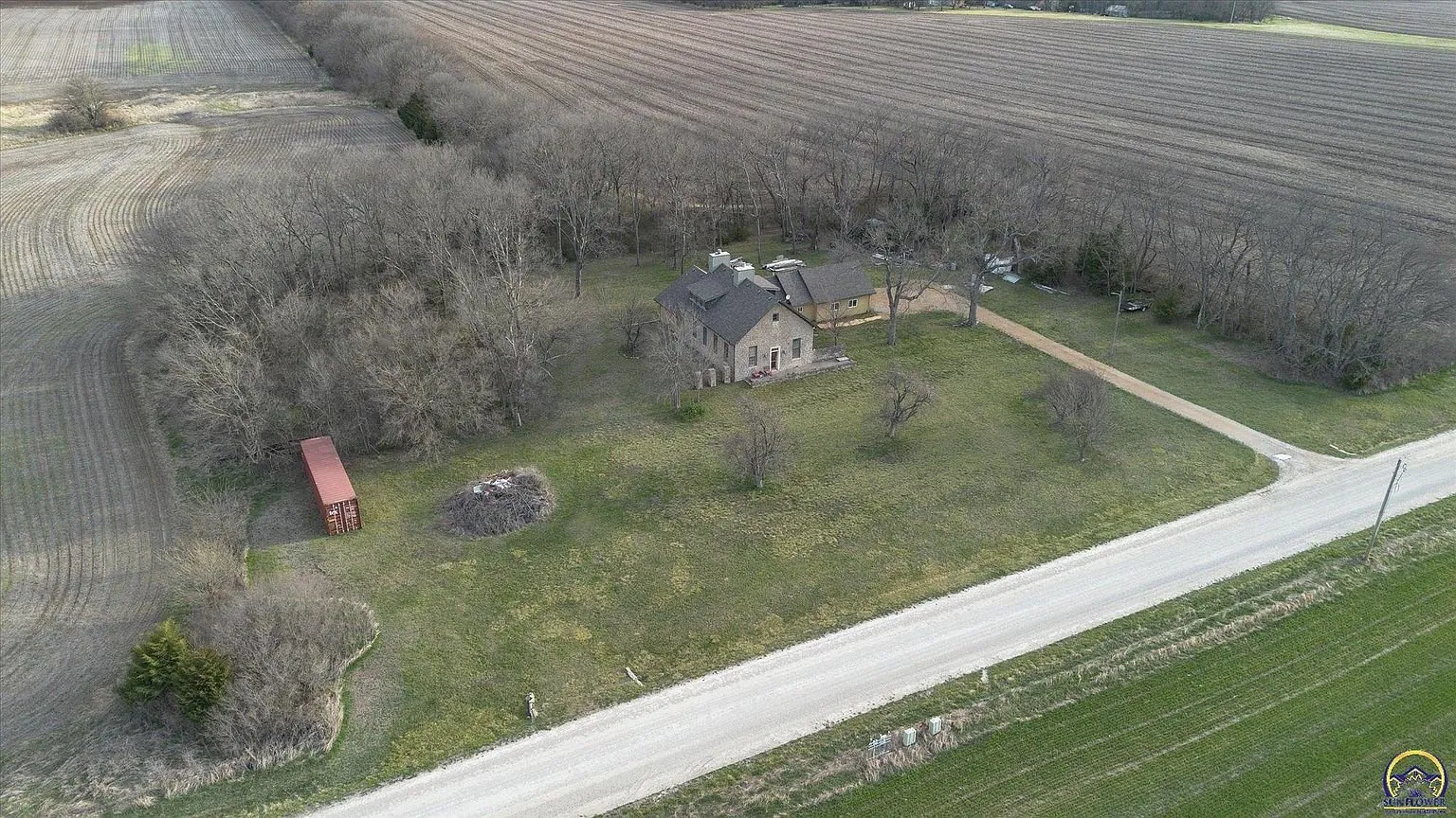 The house from the air with the road along the front