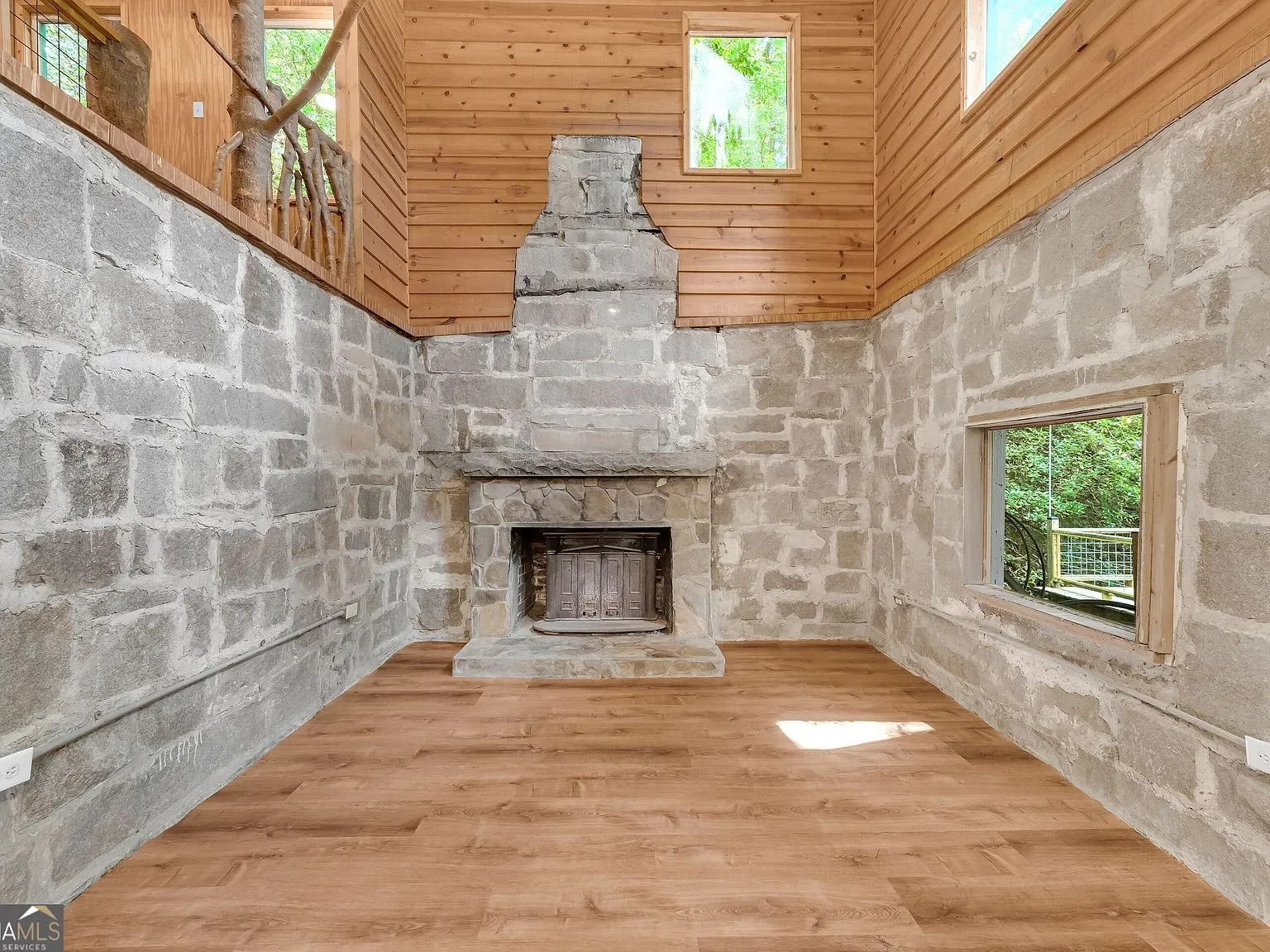 A second angle of the stone fireplace and open living area