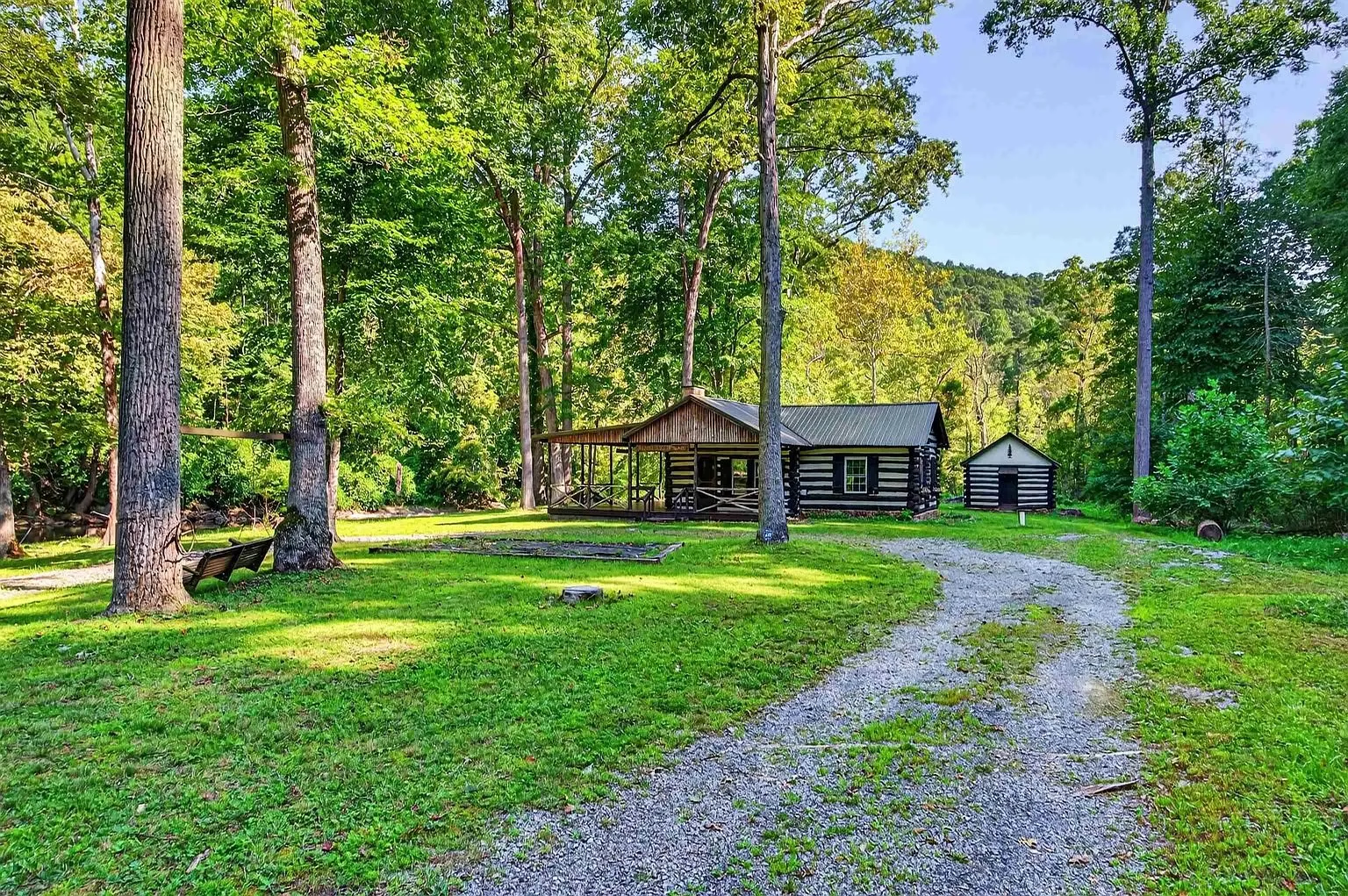 The cabin and outbuildings across the lawn