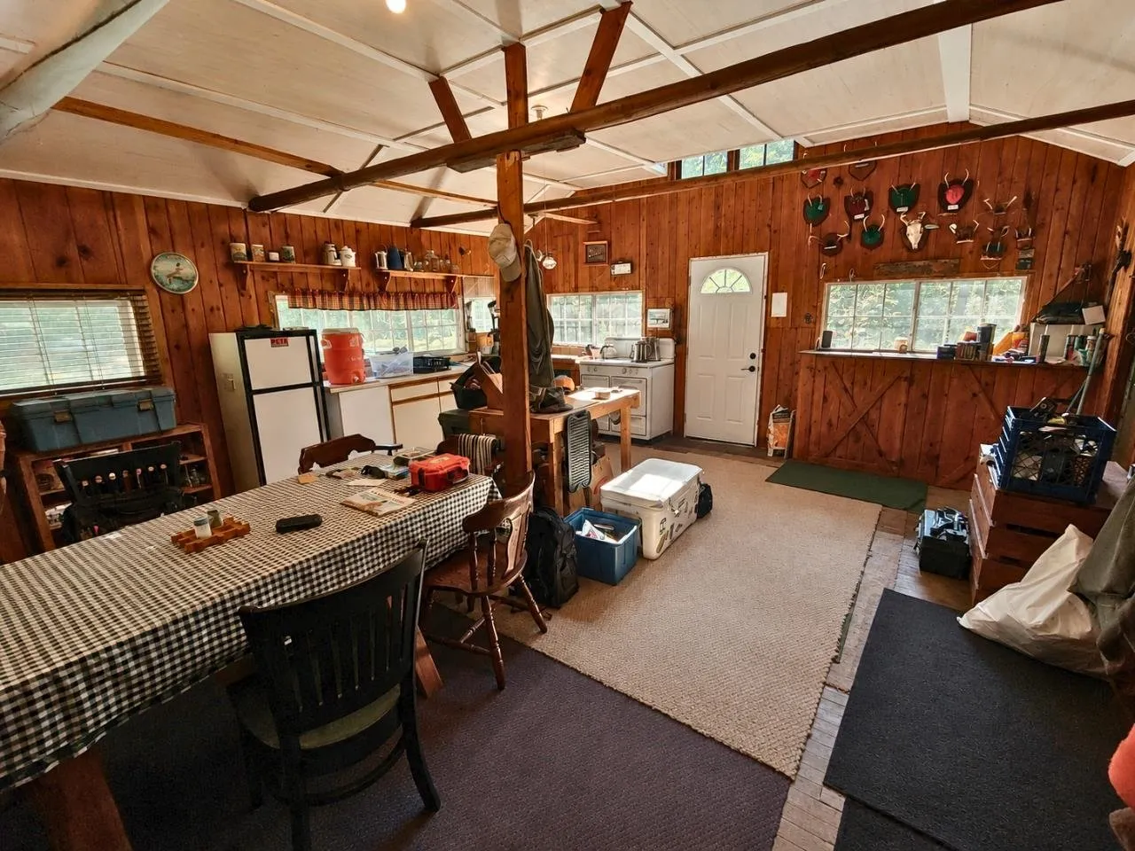 The kitchen end with the refrigerator, the range and a wall of antler mounts