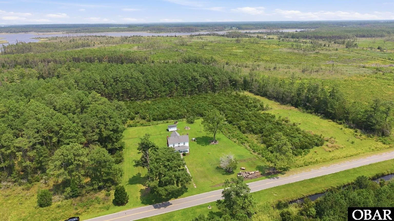 Aerial of the clearing and house from above the road