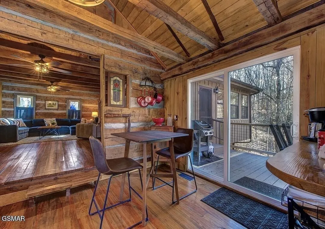 The dining table and counter seating with glass doors to the deck