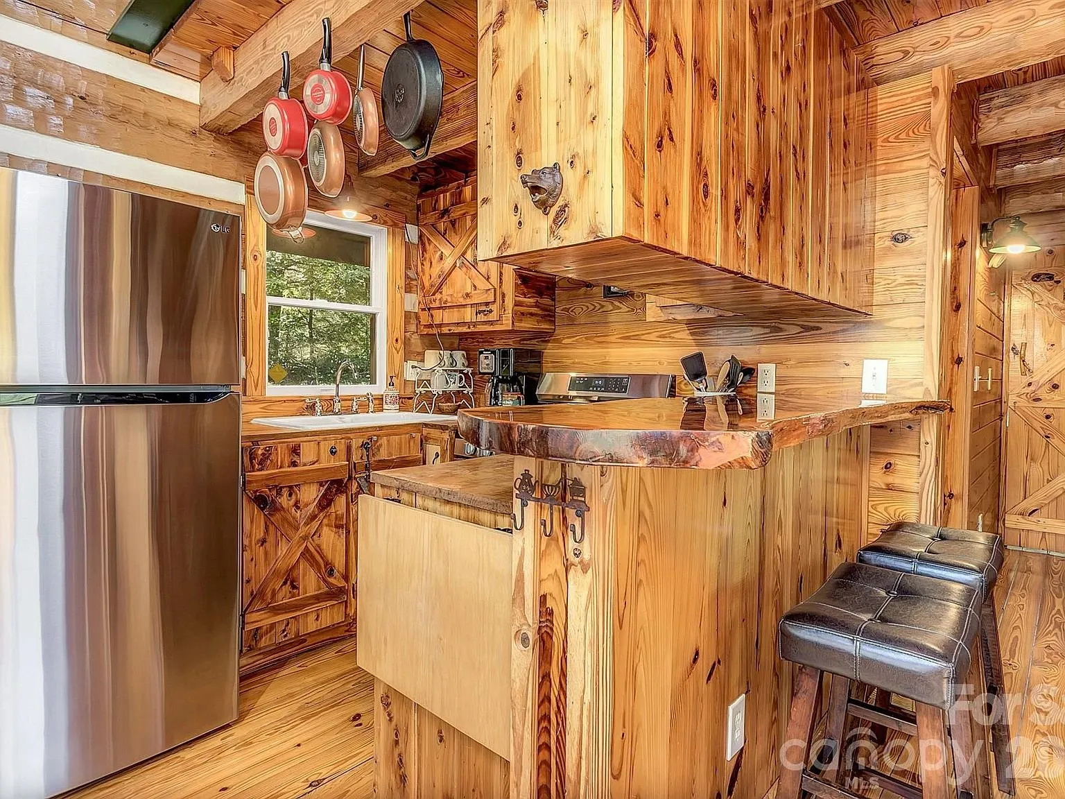 The kitchen with a stainless refrigerator and live-edge wood counters