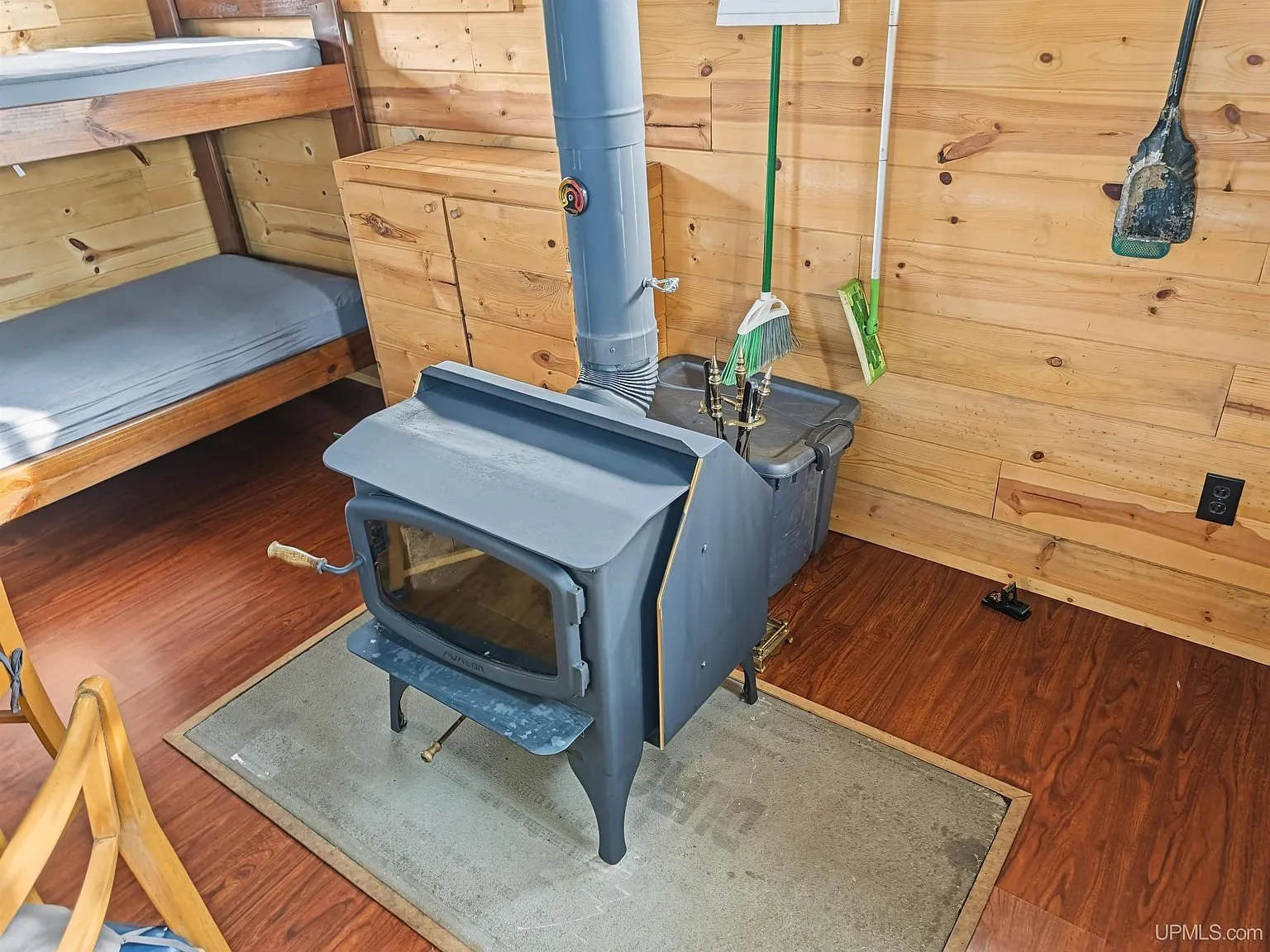 A table, chairs and bunk beds under the sloped ceiling