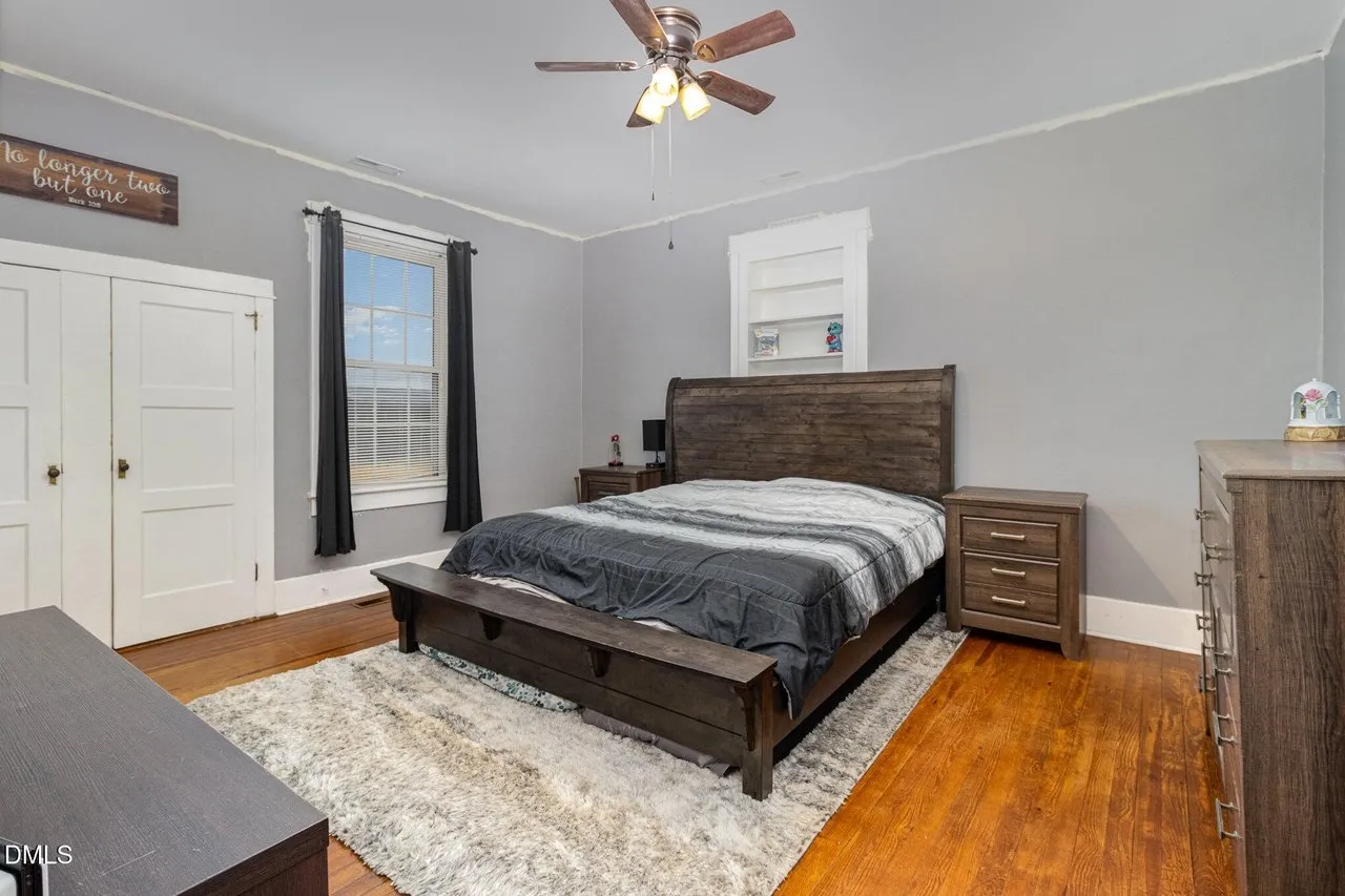 Second bedroom with wood floors and a window to the front