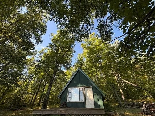 The front of the A-frame with the door and the deck