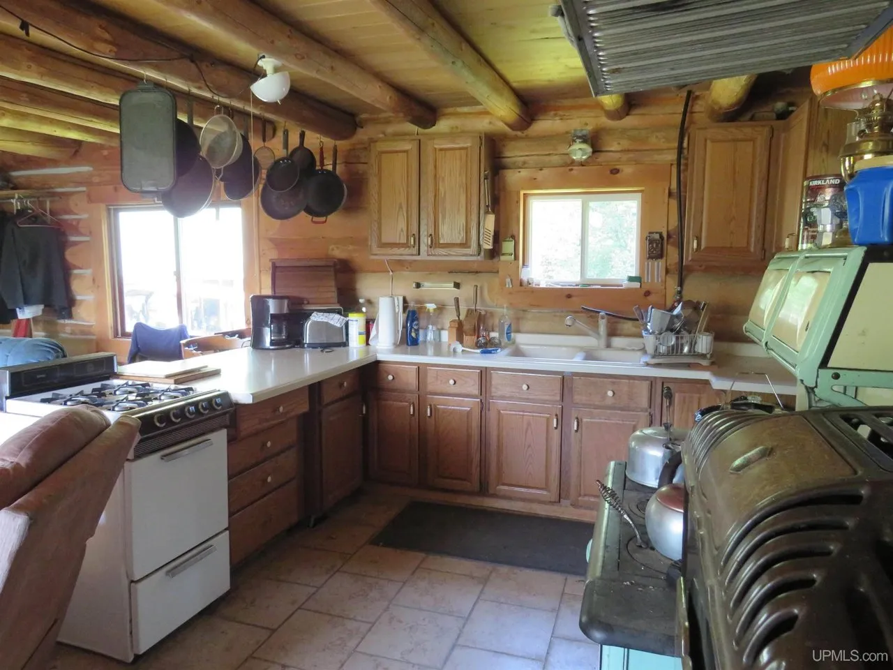 The kitchen counter and sink under the window