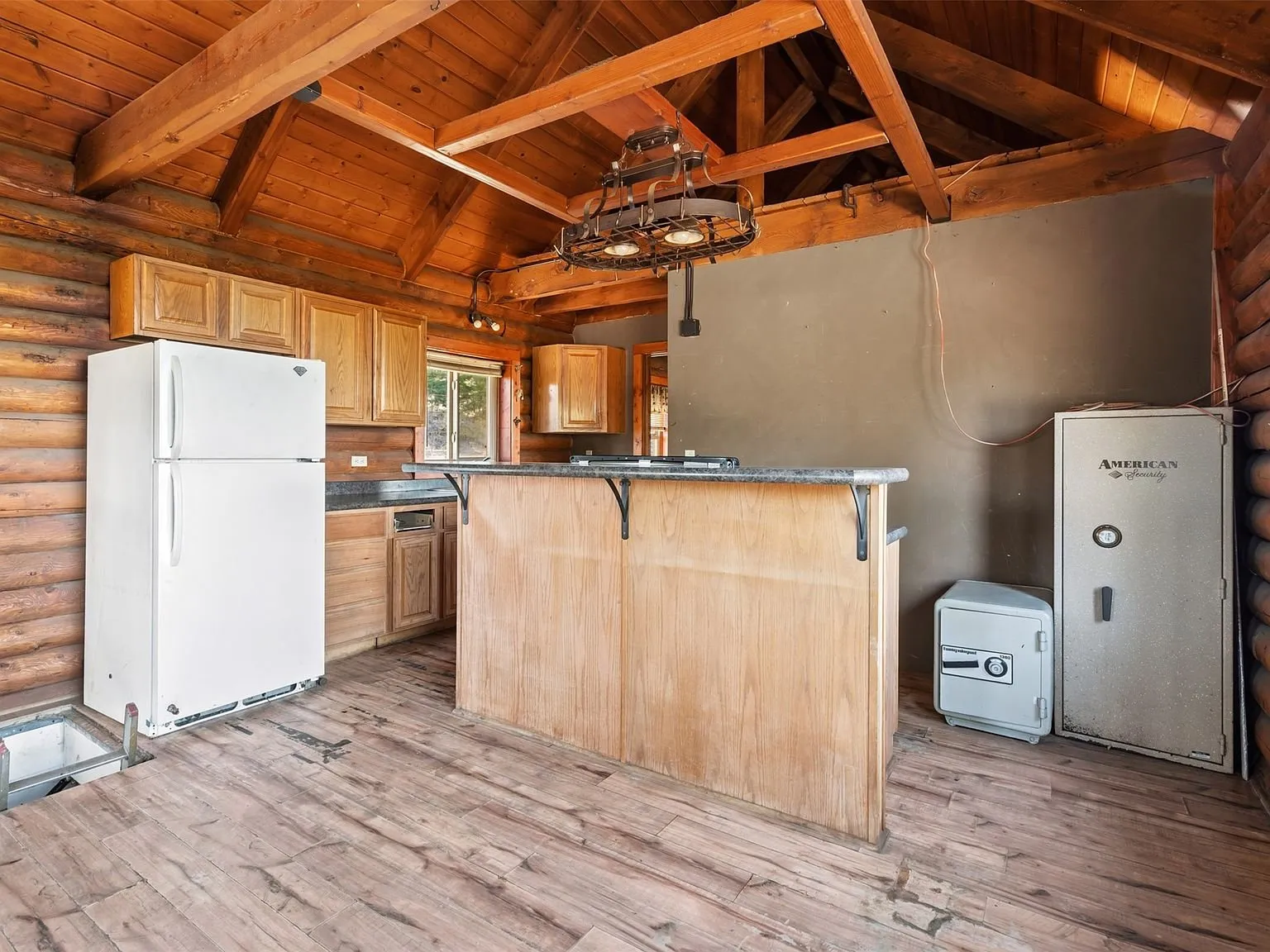 The kitchen counter with granite-look countertop, sink and cabinetry