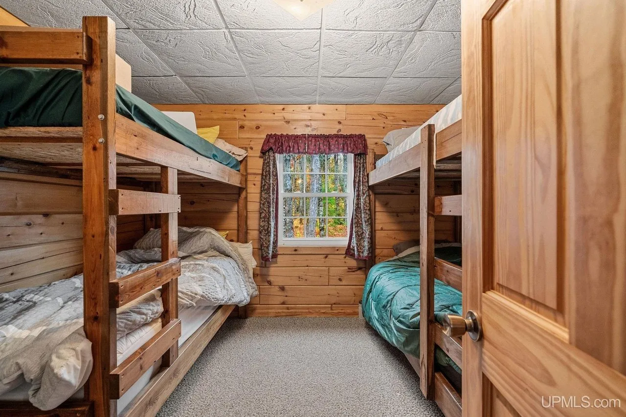 The second bunk room, bunks along both walls with bedding made up