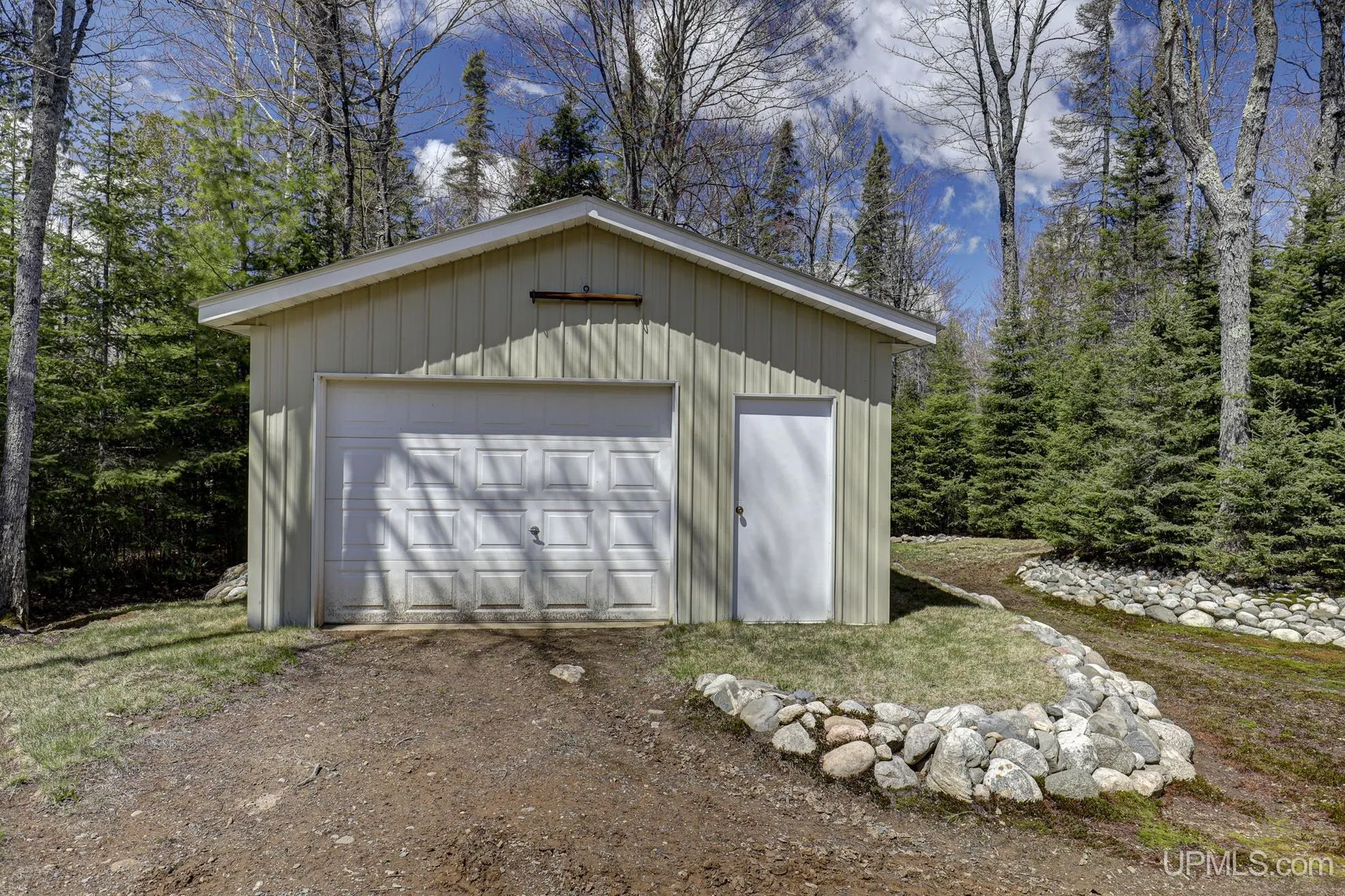 The garage with its overhead door and a stone border