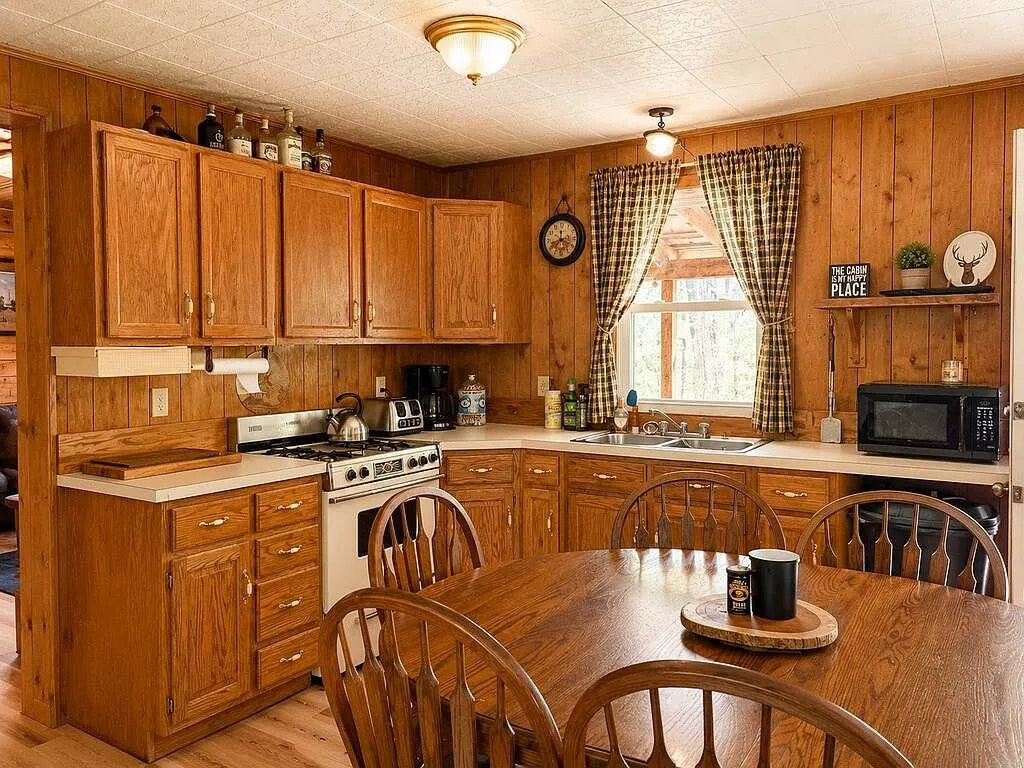 The kitchen with oak cabinets, range and microwave