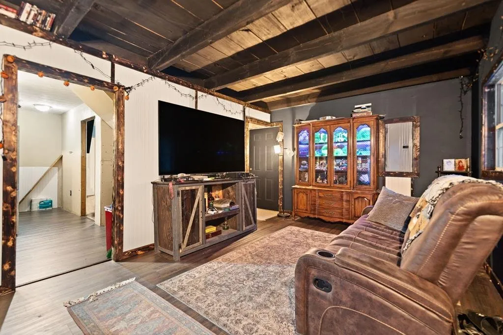 The living room from the other side, television on the wall and recliners