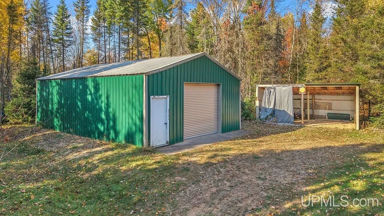 The detached garage building's exterior with its overhead door