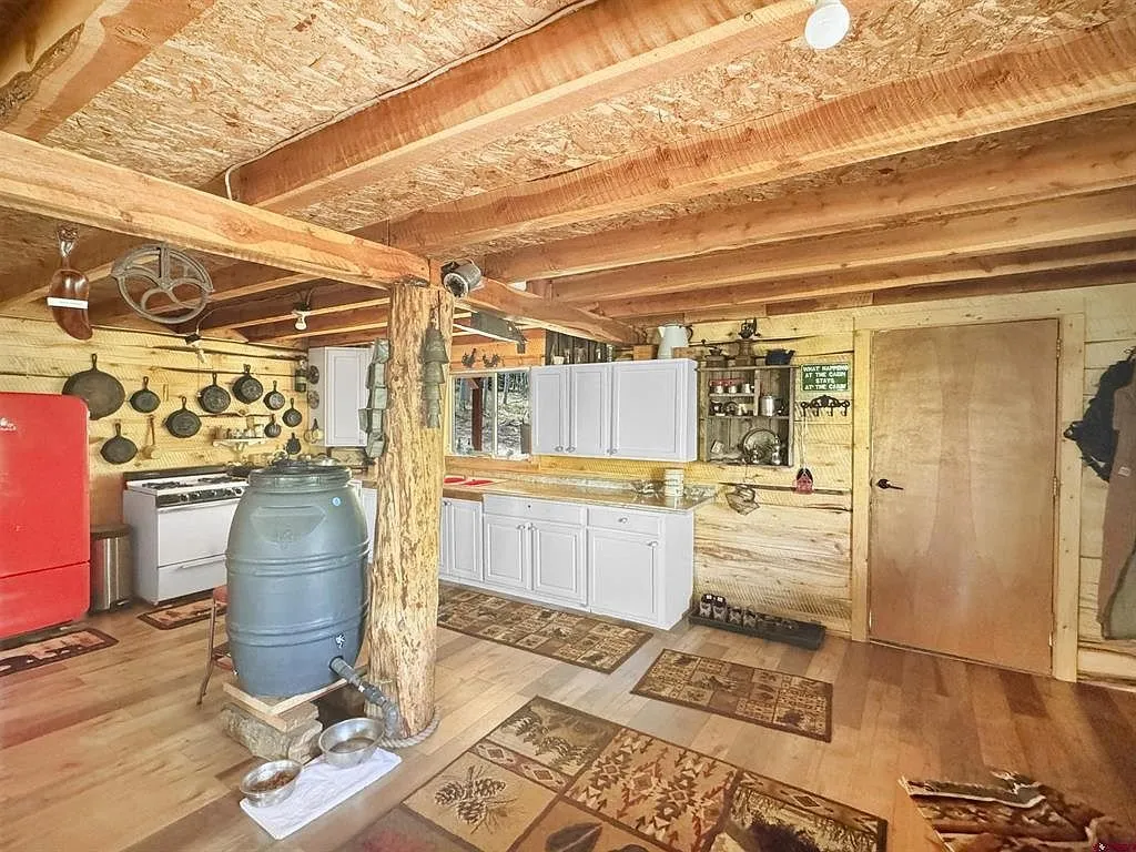 The kitchen toward the water barrel and the cabinets