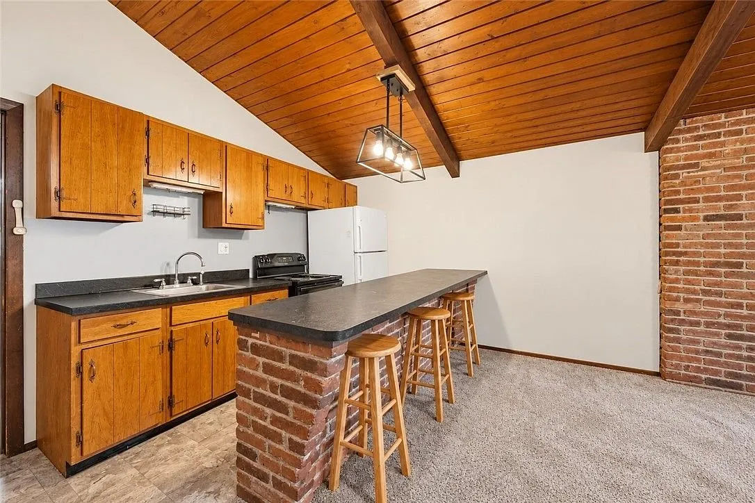 The kitchen counters and cabinets along the far wall