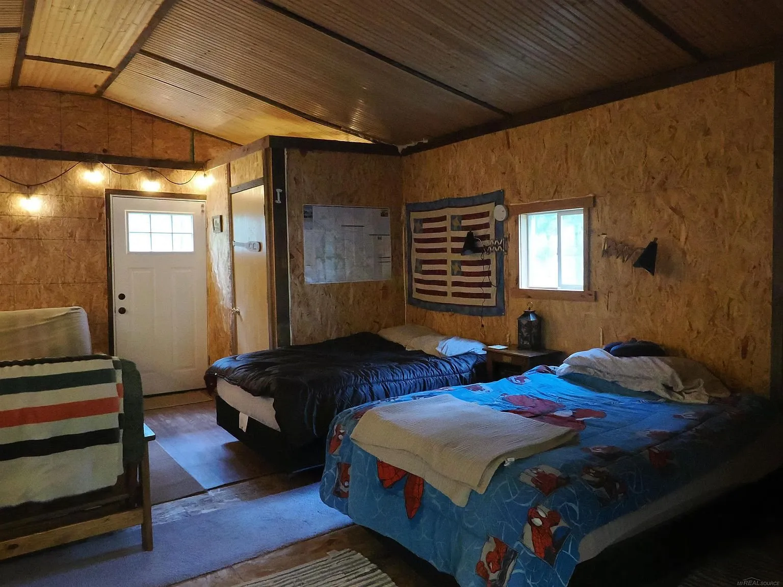 The bunk room with the beds and the door to the porch