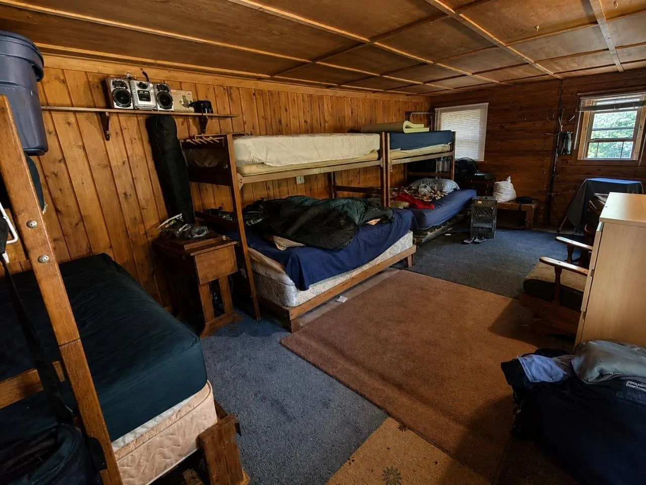 The bedroom with bunk beds along the knotty pine walls