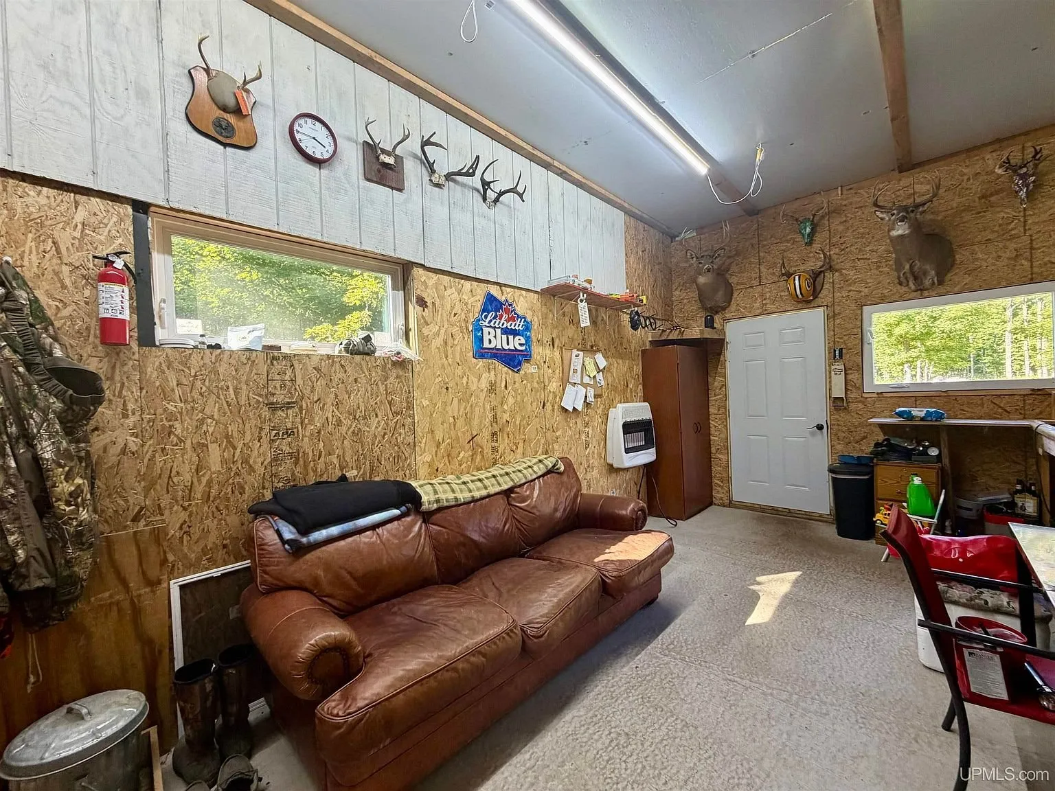 The sofa in the base camp with the wall heater and the door