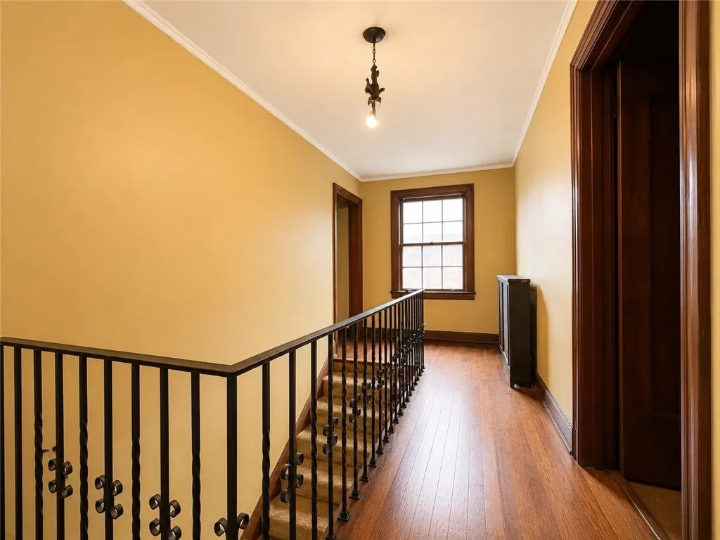 The upstairs hall from the other end with hardwood floors