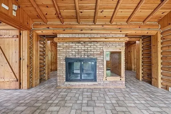 The fireplace from the other side with the log walls and the tiled floor