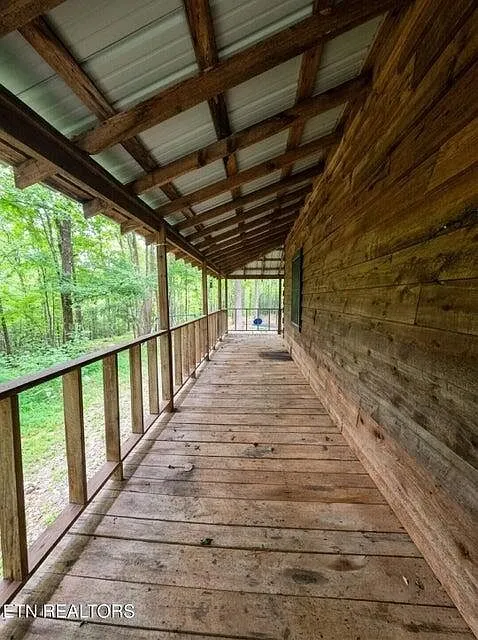 The covered wraparound porch running the length of the cabin's side