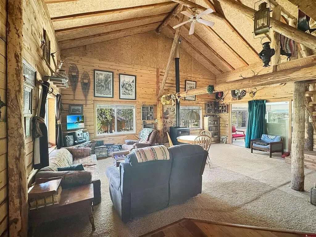 The living room with the sofa, the log posts and the mounts on the wall