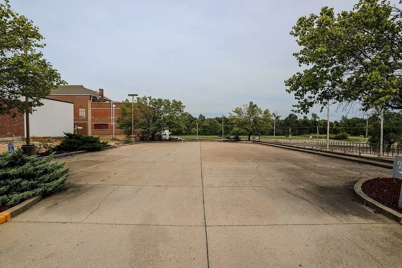 The concrete parking lot across the street from the building