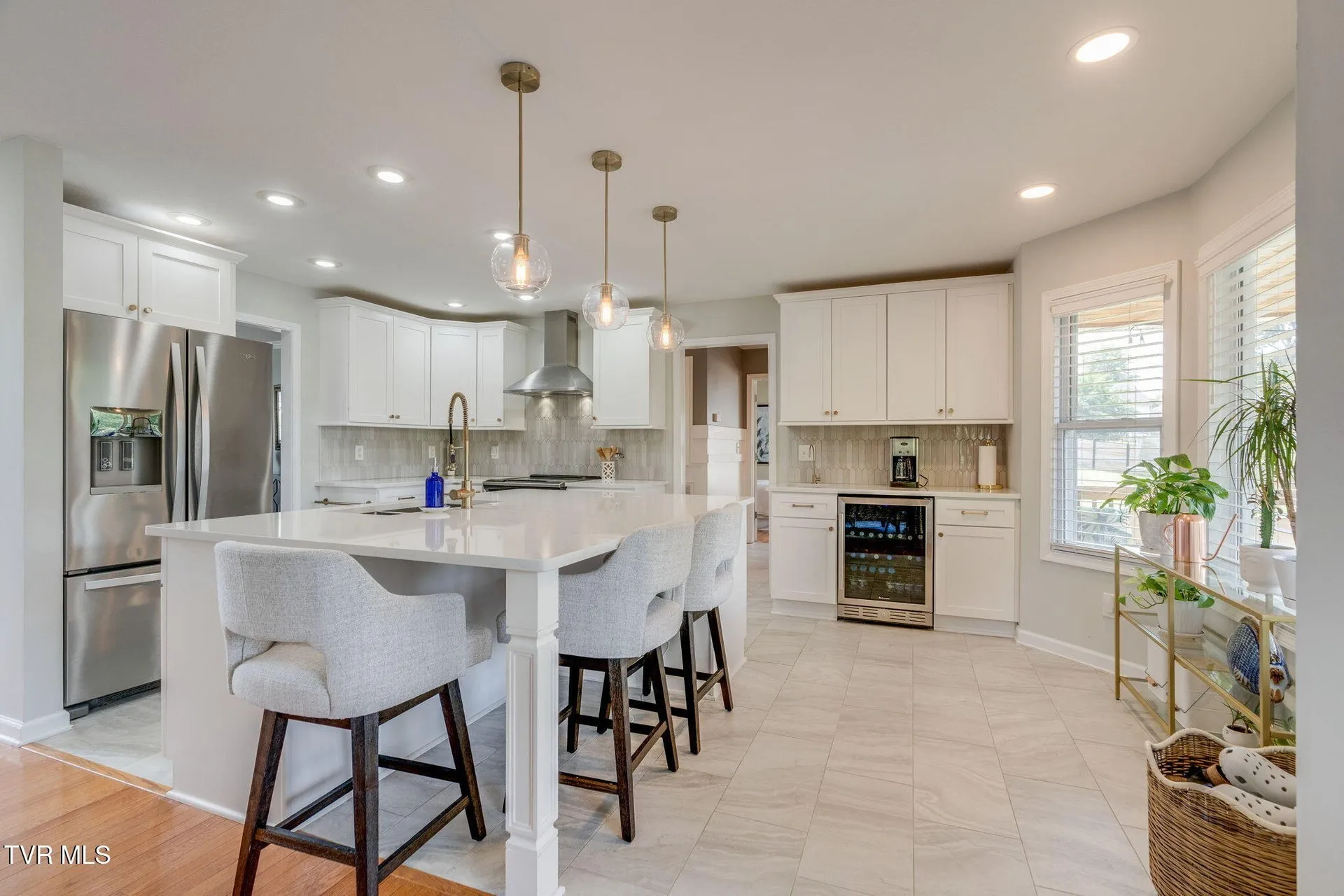 The kitchen island with seating for three under the pendants