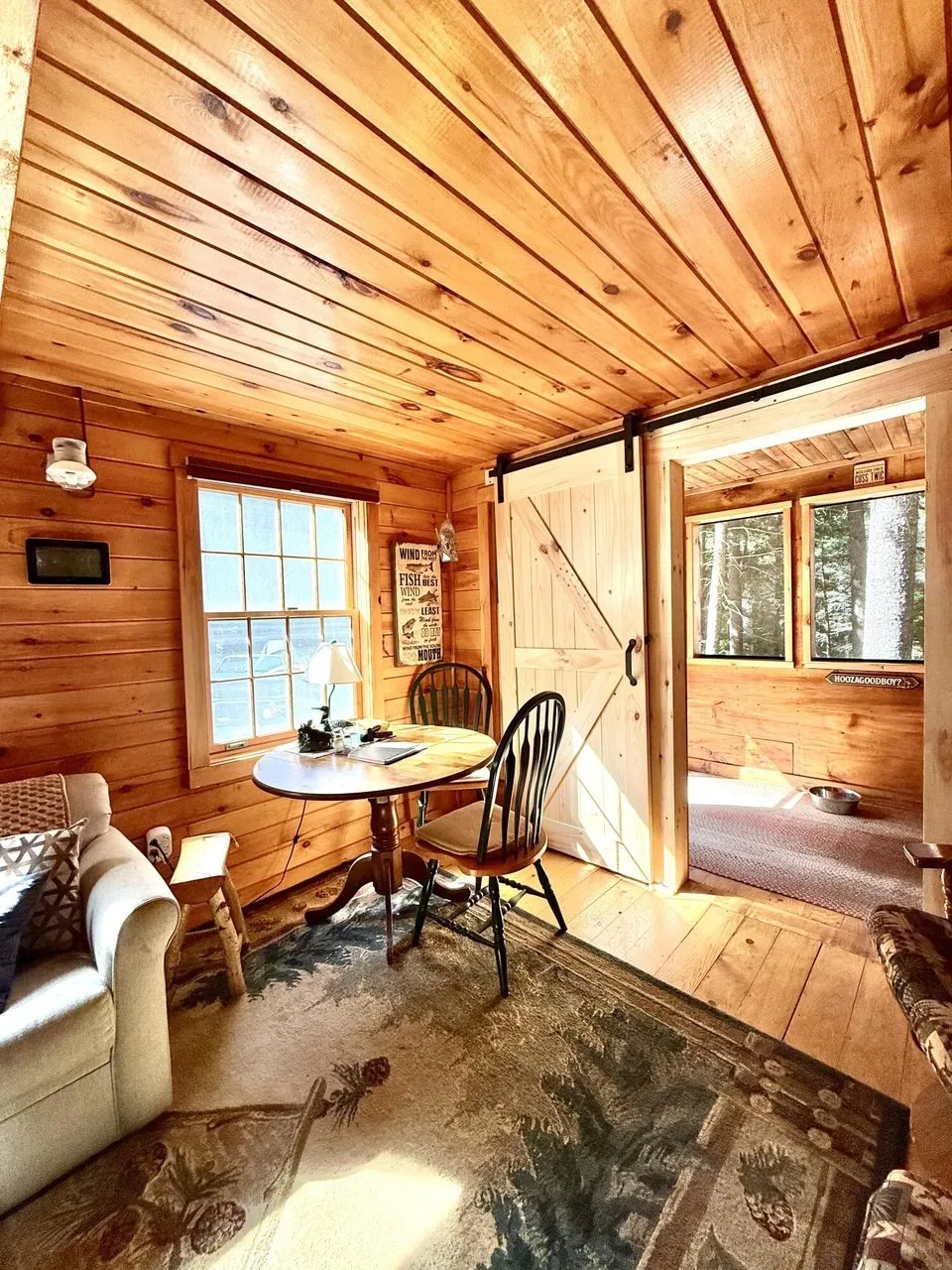 The sitting area with the table and the sliding barn door