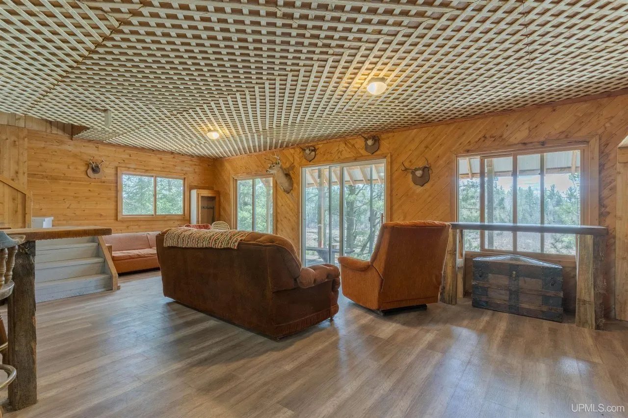 The living room with couches and windows facing the river
