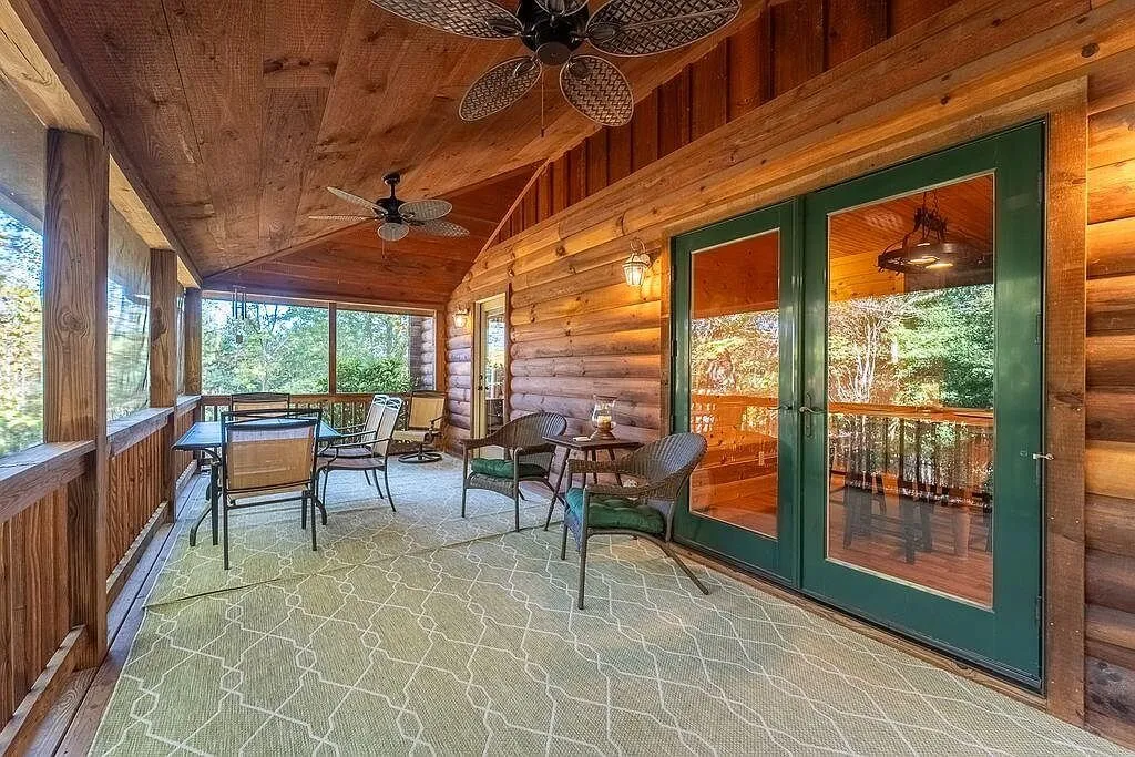 The screened porch looking out through the screens into the trees