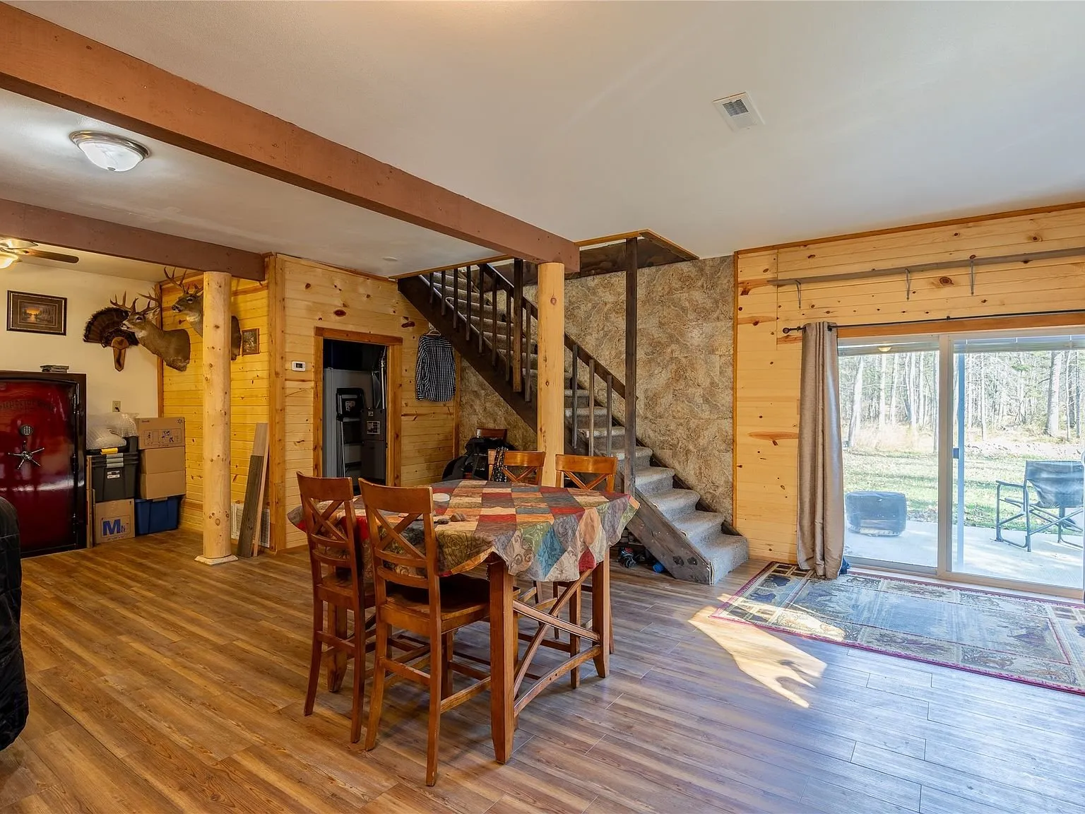 A second living room seating area with a sectional and wood stove