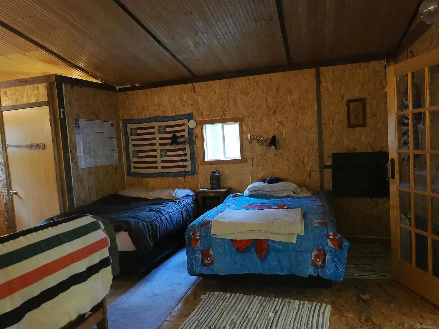 The bunk room from the doorway with the beds and the rug
