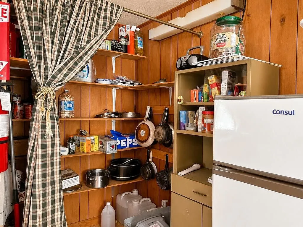 The pantry shelves beside the refrigerator