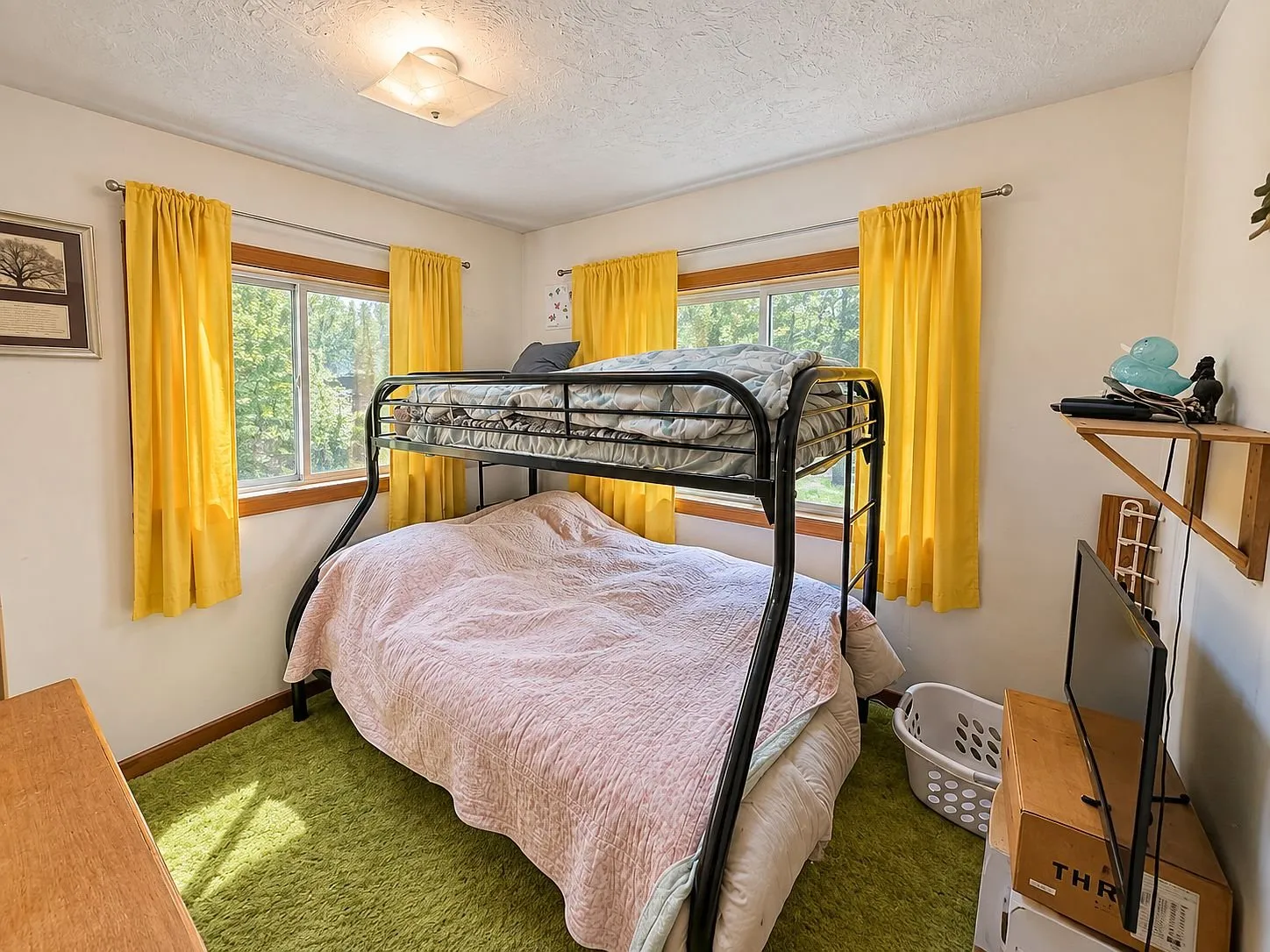 A bedroom with the bunk bed and the yellow curtains