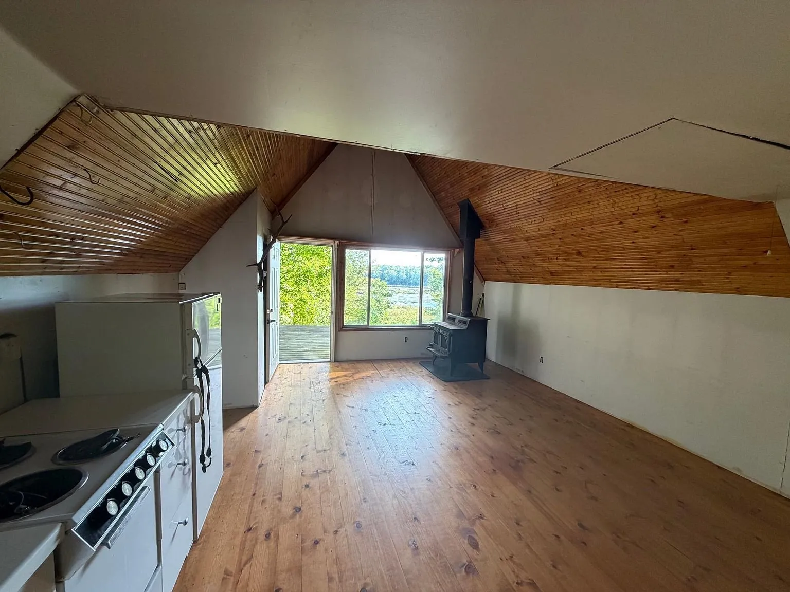 The main room toward the glass door and the deck