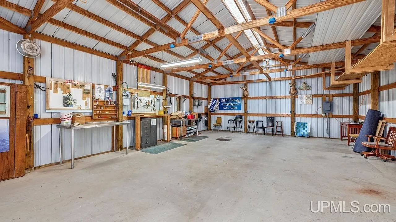 Inside the detached garage with its concrete floor and open bay