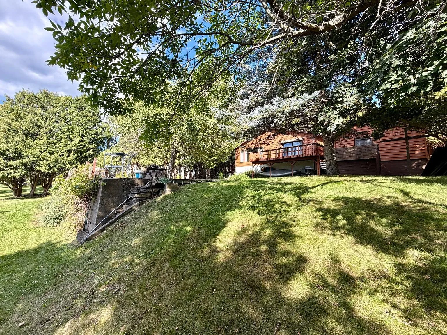 The bank below the house with the deck above
