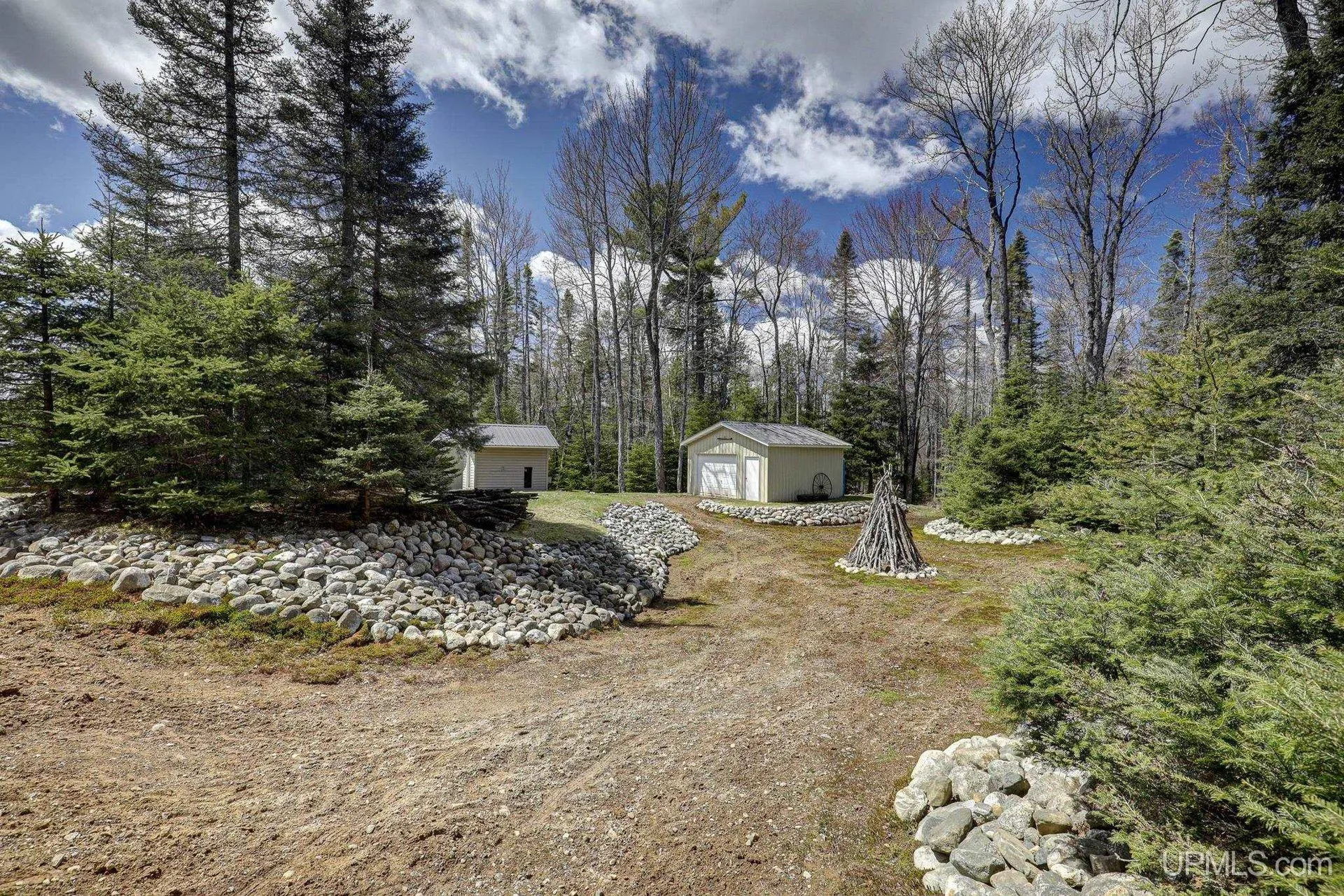 The path from the cabin to the sheds, edged with stones