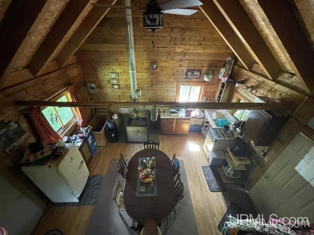 The open interior from above, kitchen and table under the vaulted roof