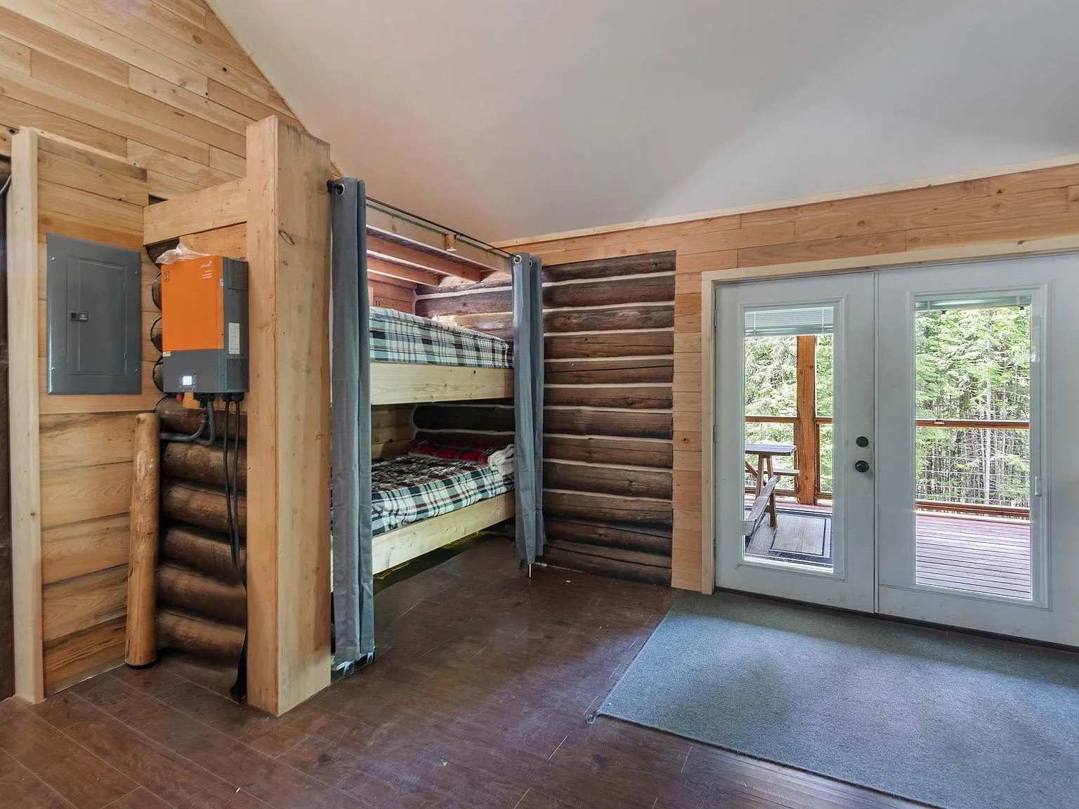 A built-in bunk bed nook with its own window and French doors nearby