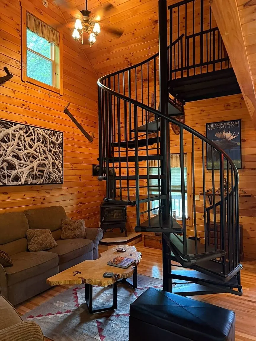 The living room with the sofa and the spiral stair to the loft