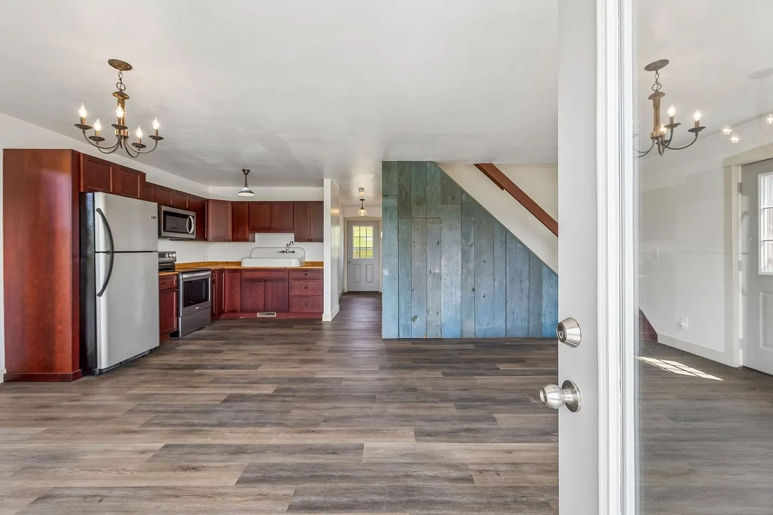 The kitchen with cherry cabinets and stainless appliances beside the stair