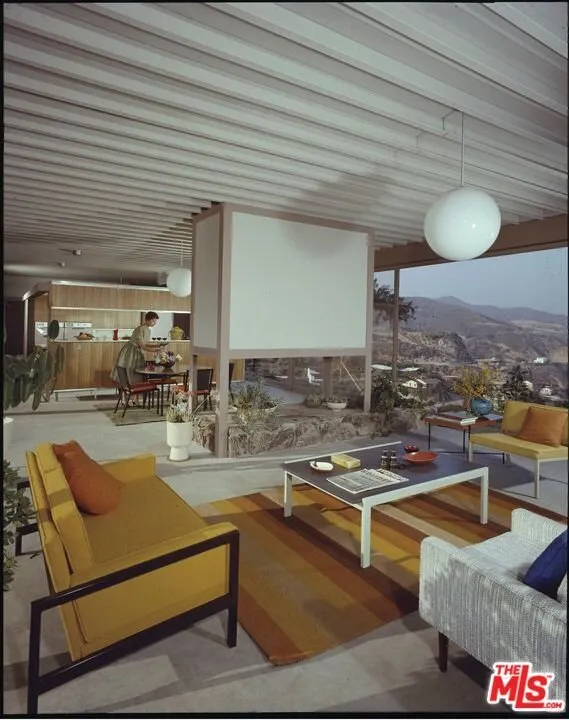 A seating area with period furniture under the exposed steel deck ceiling