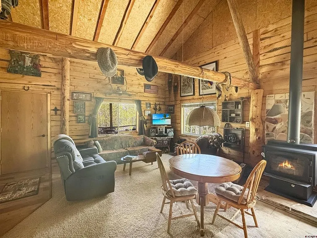 The living room with the table, the recliner and the wood stove