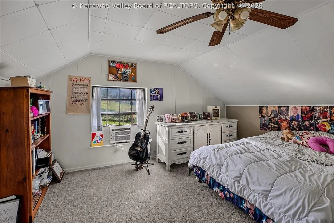 The upstairs landing with a built-in bookshelf and stairway rail