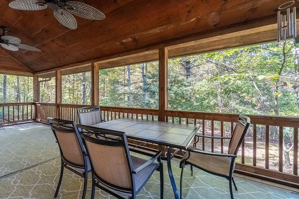 A patio table and chairs set on the screened porch