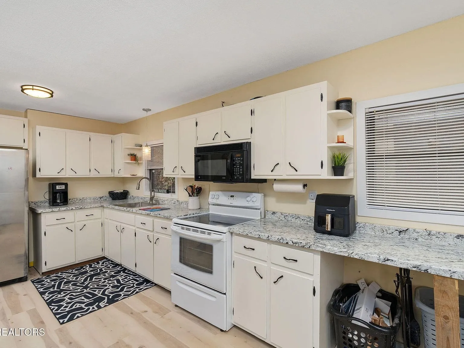 A side entry door and dining space off the kitchen with a dark accent wall